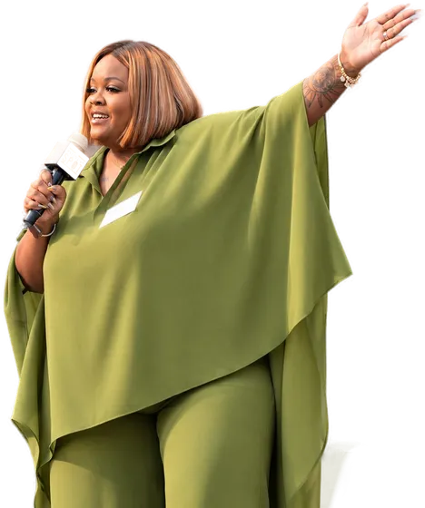 Kayla Life on stage, microphone in hand, arm outstretched toward the audience